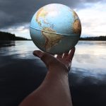 person holding clear glass ball